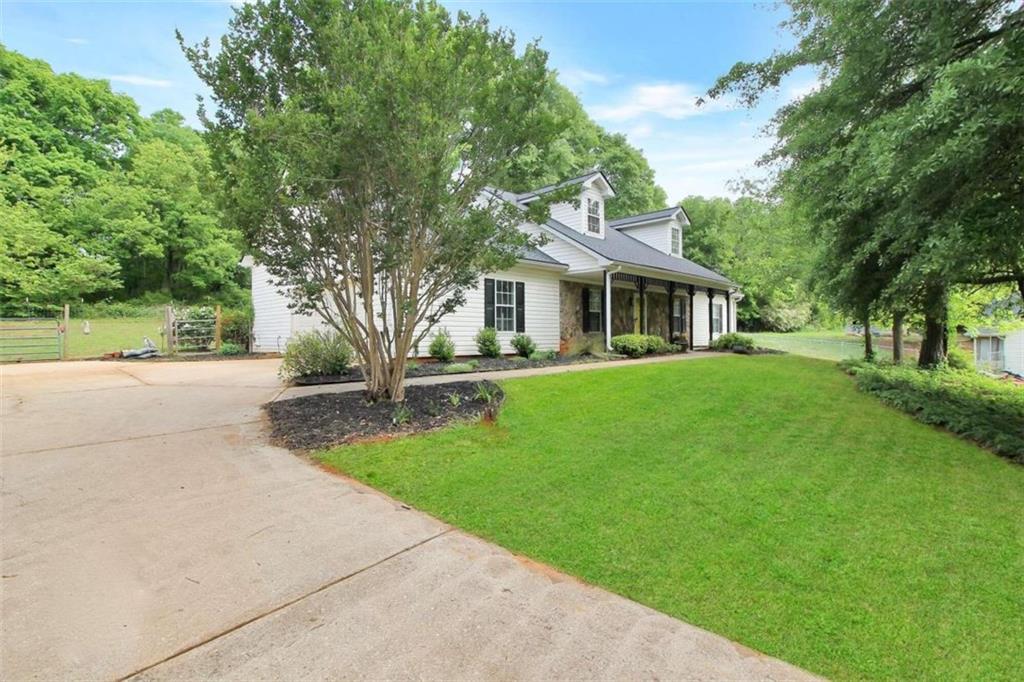 a front view of house with yard and green space