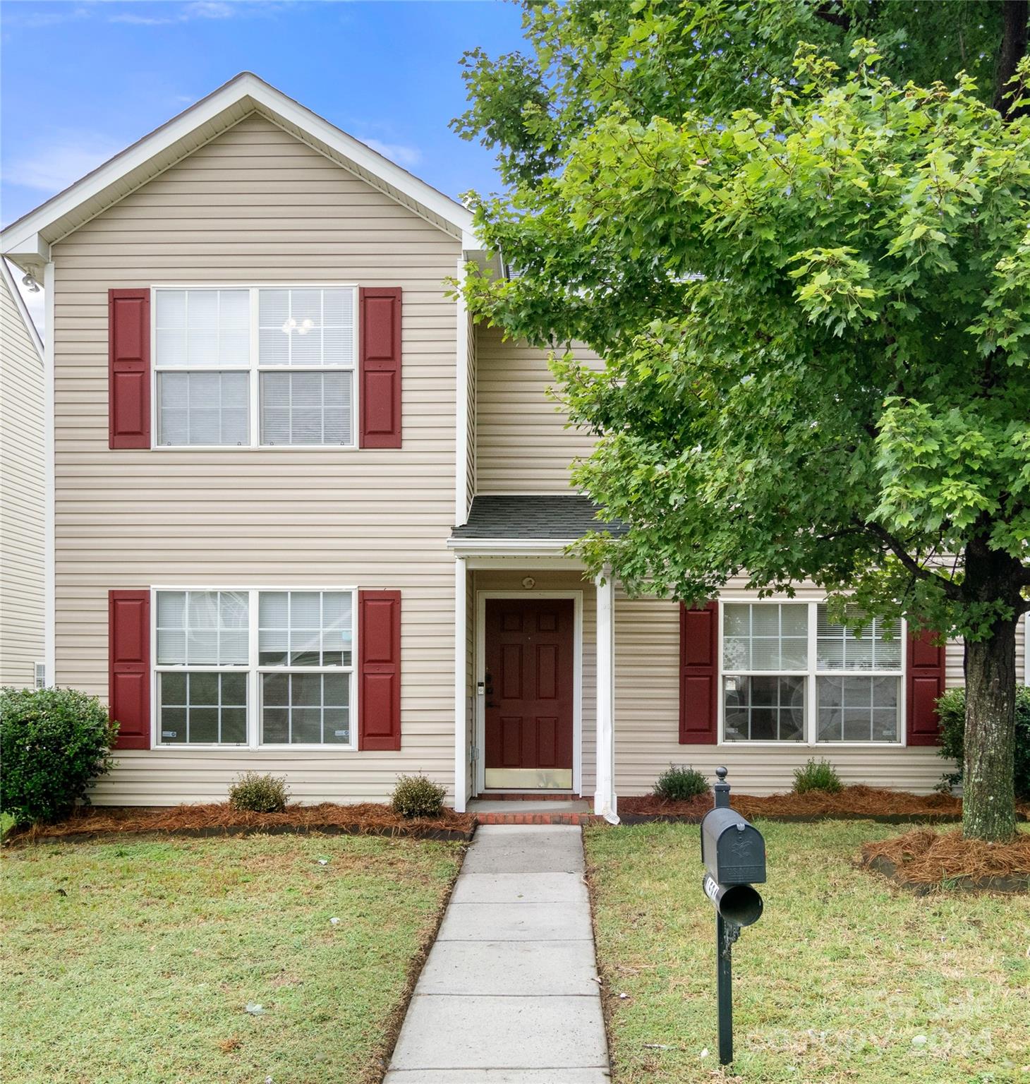 a front view of a house with a yard