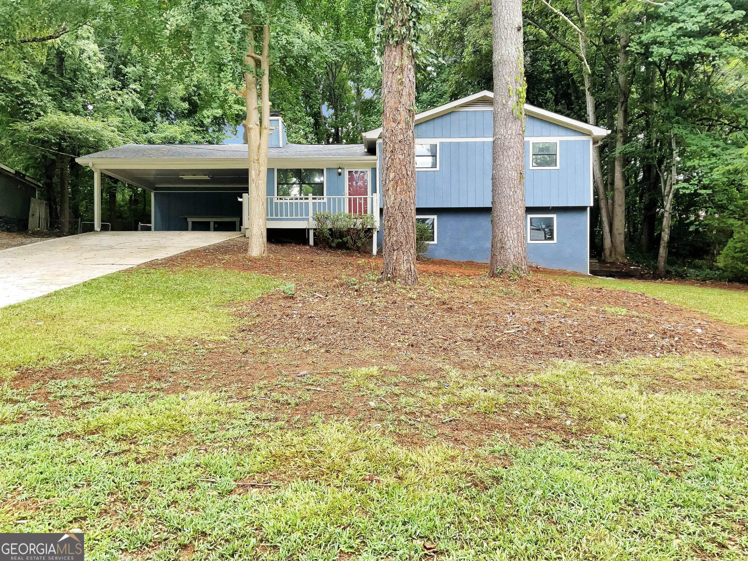 a front view of a house with a garden