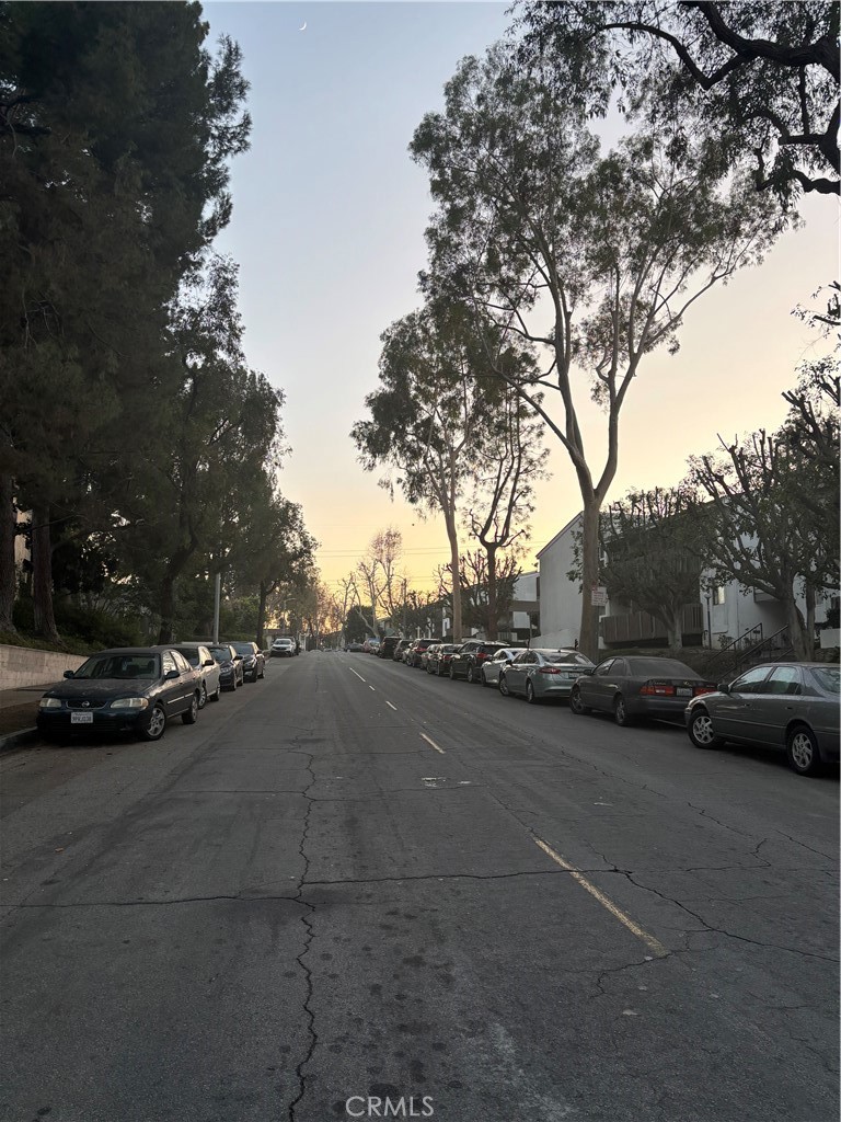 a view of street with parked cars