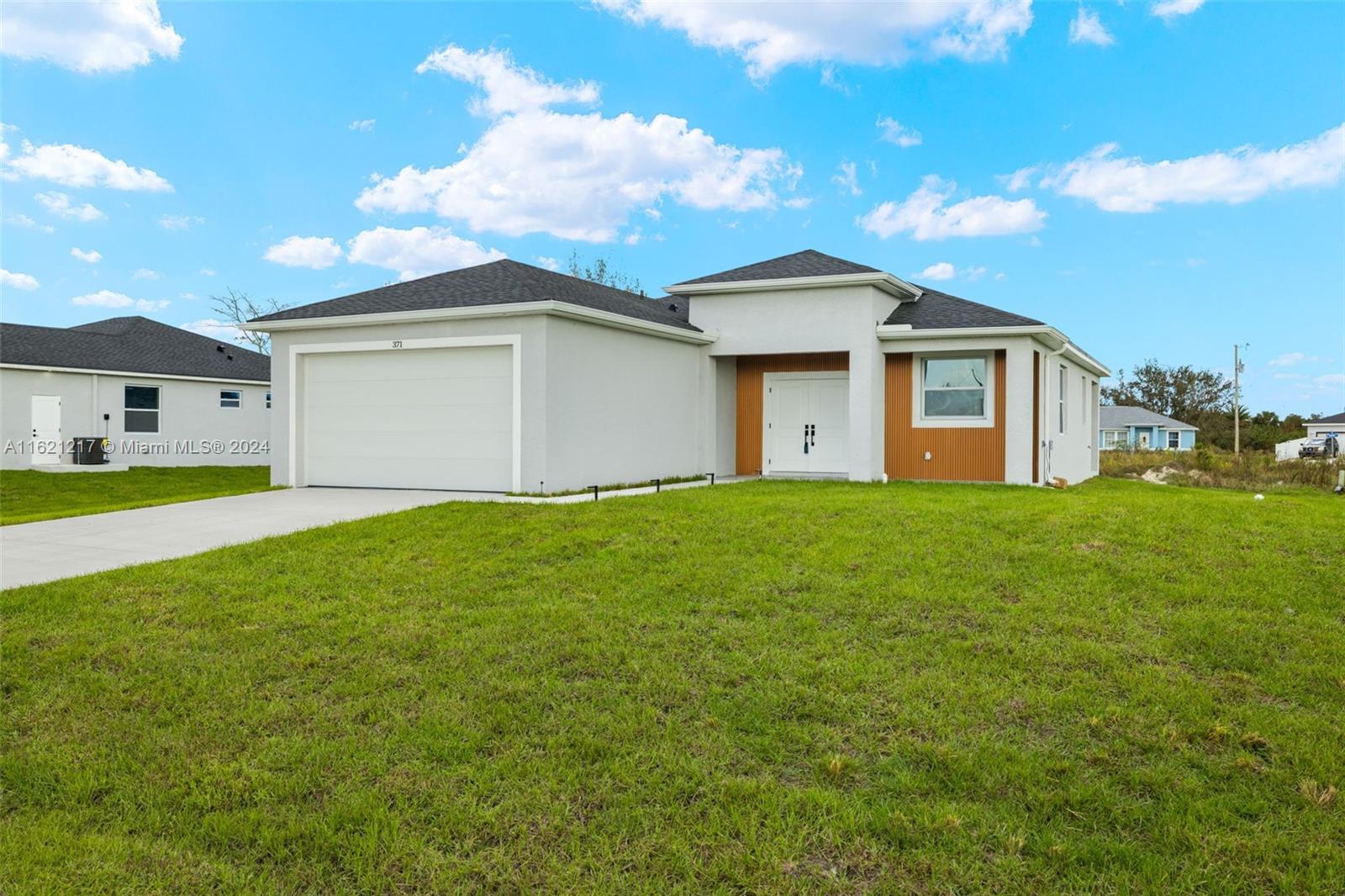 a front view of house with yard and green space