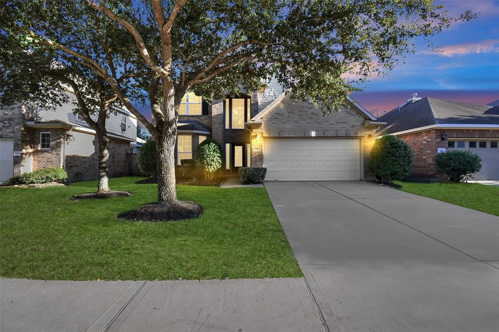 a front view of house with yard and green space