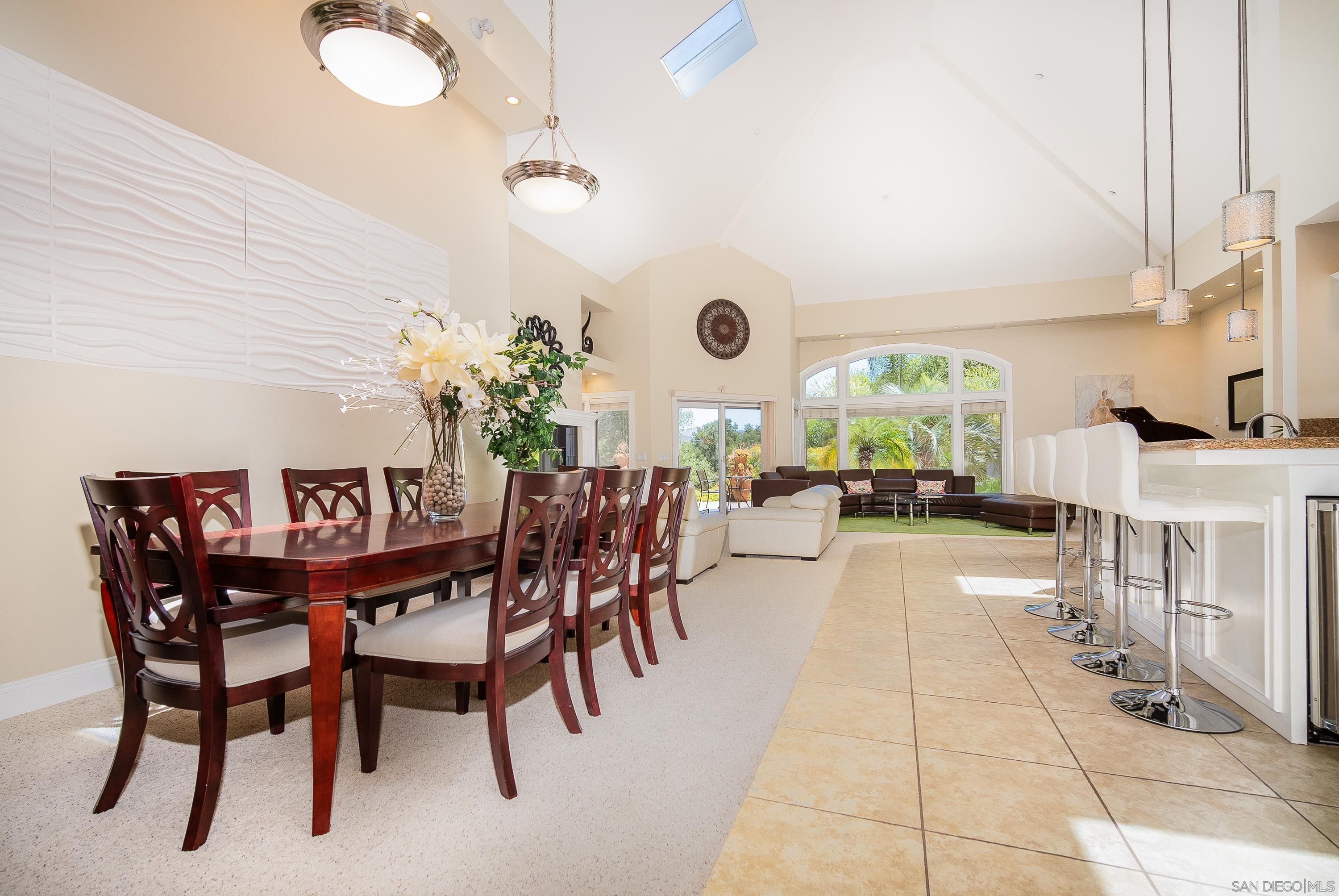 a dining room with furniture and a large window