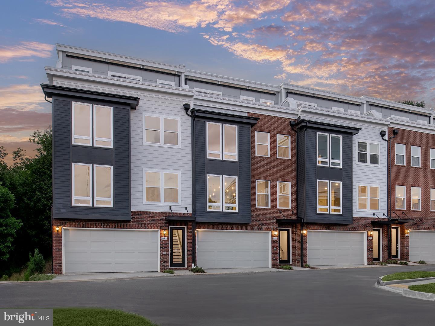 a front view of a residential apartment building with a yard