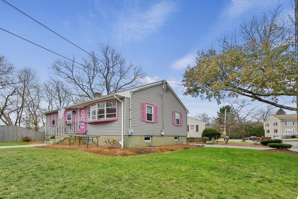 a front view of house with yard and trees