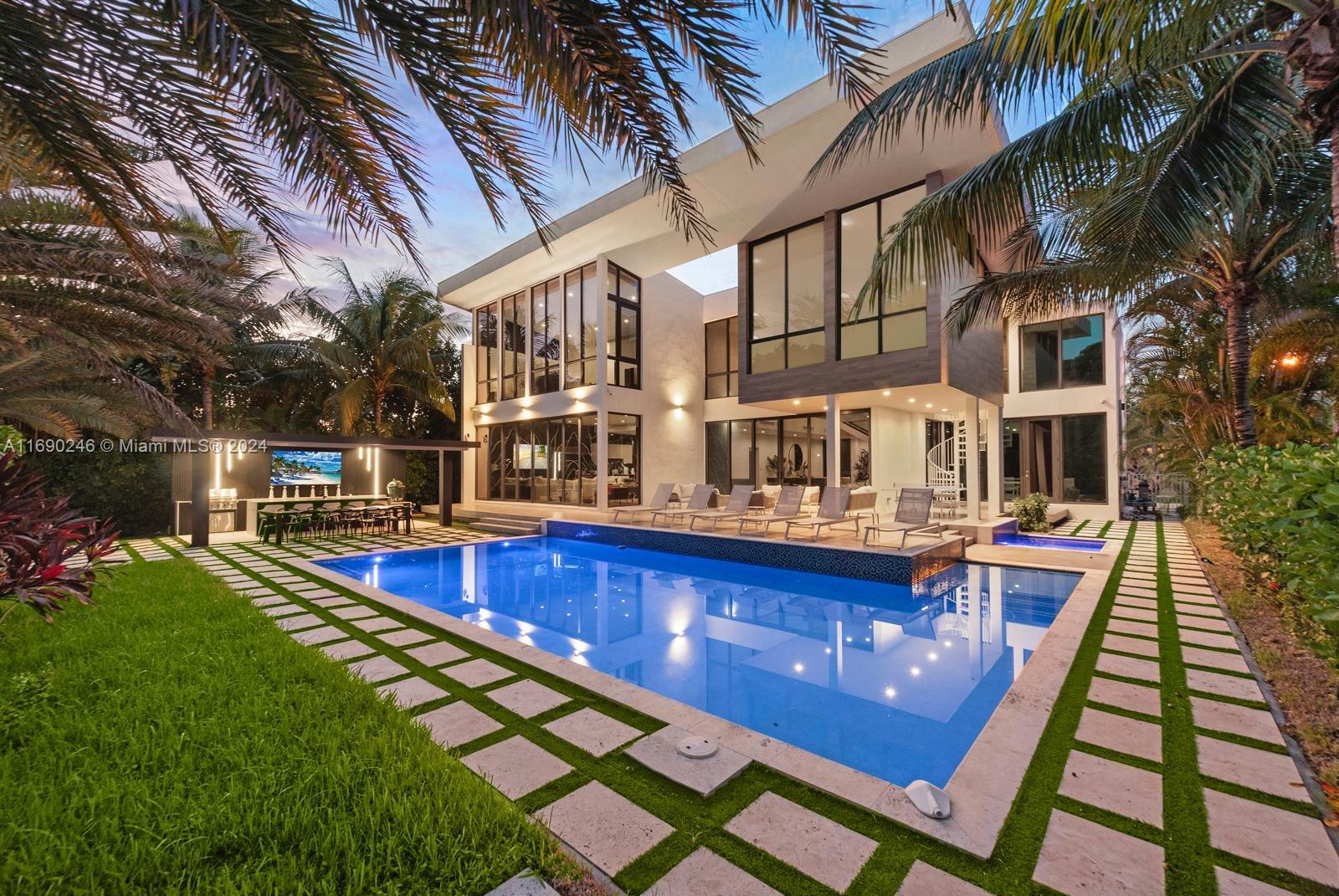 a view of a house with pool and sitting area