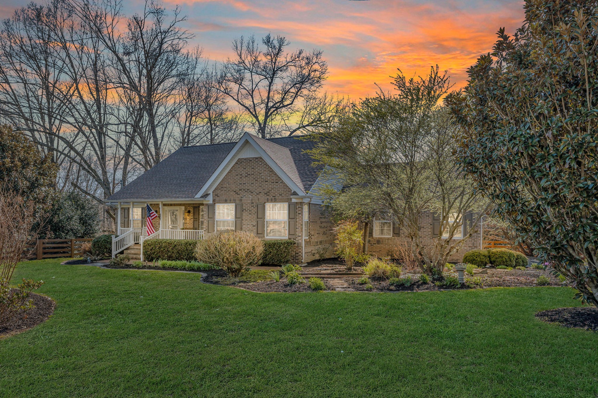 a front view of house with yard and green space