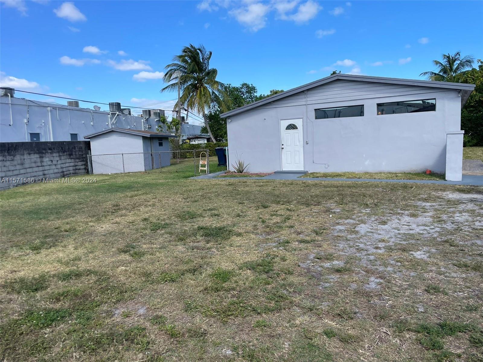 a front view of house with yard and trees