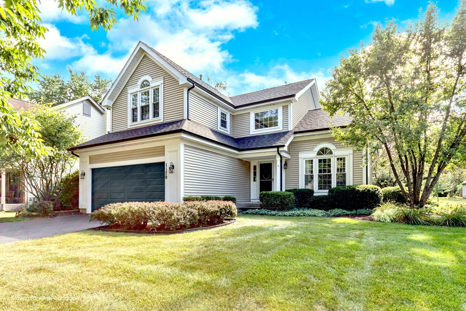 a front view of a house with a yard and garage