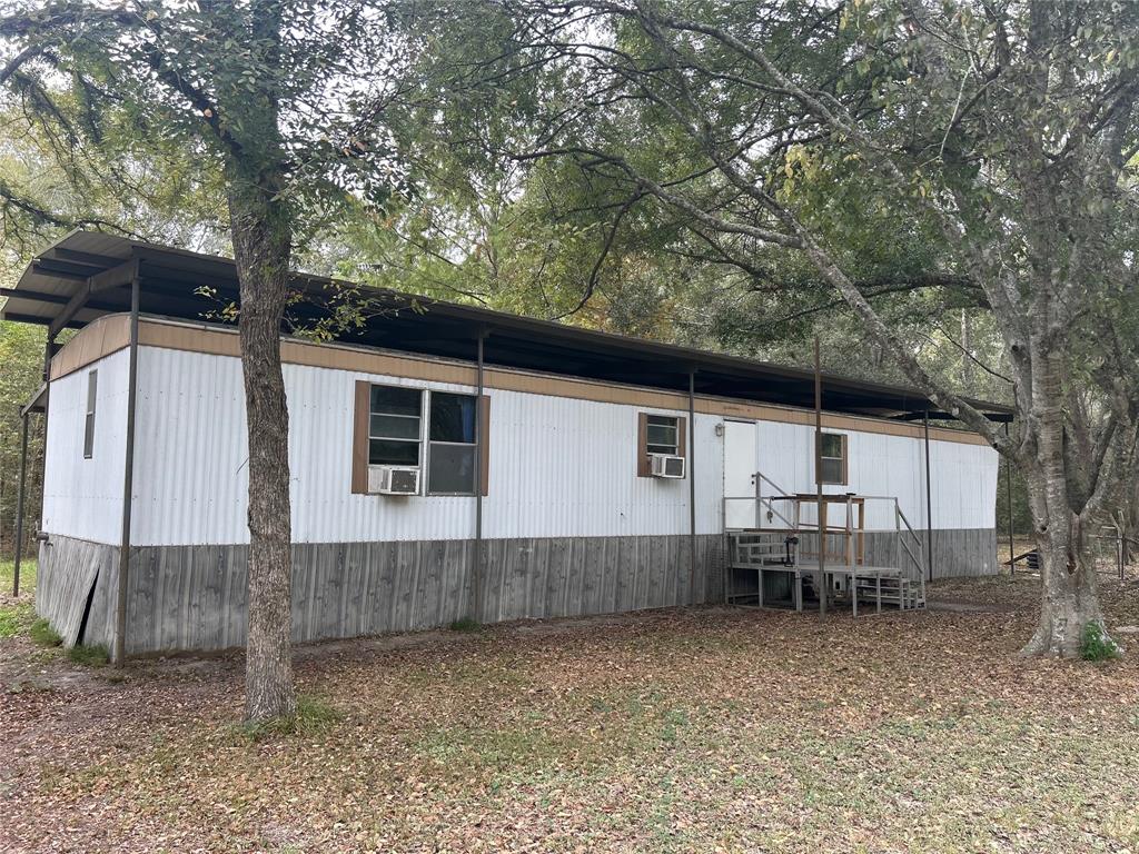 a backyard of a house with barbeque oven