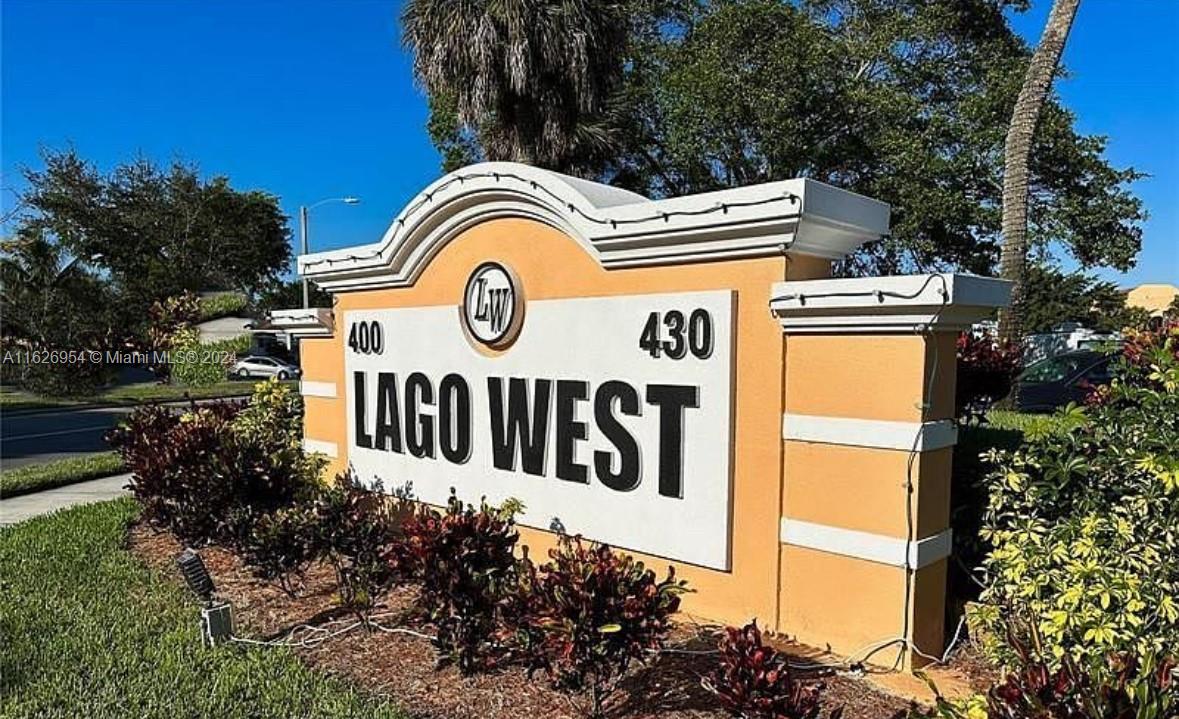 a view of sign board with a white house