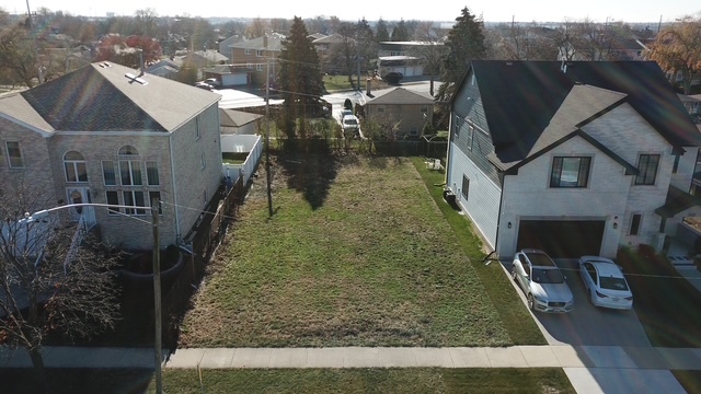 a aerial view of a house with a yard