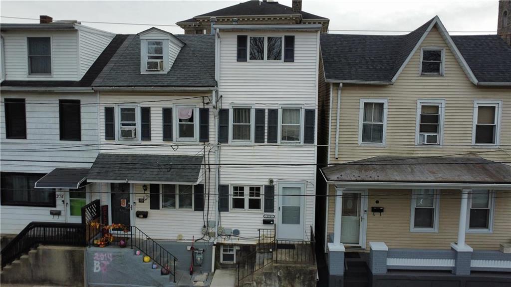 a front view of a house with many windows