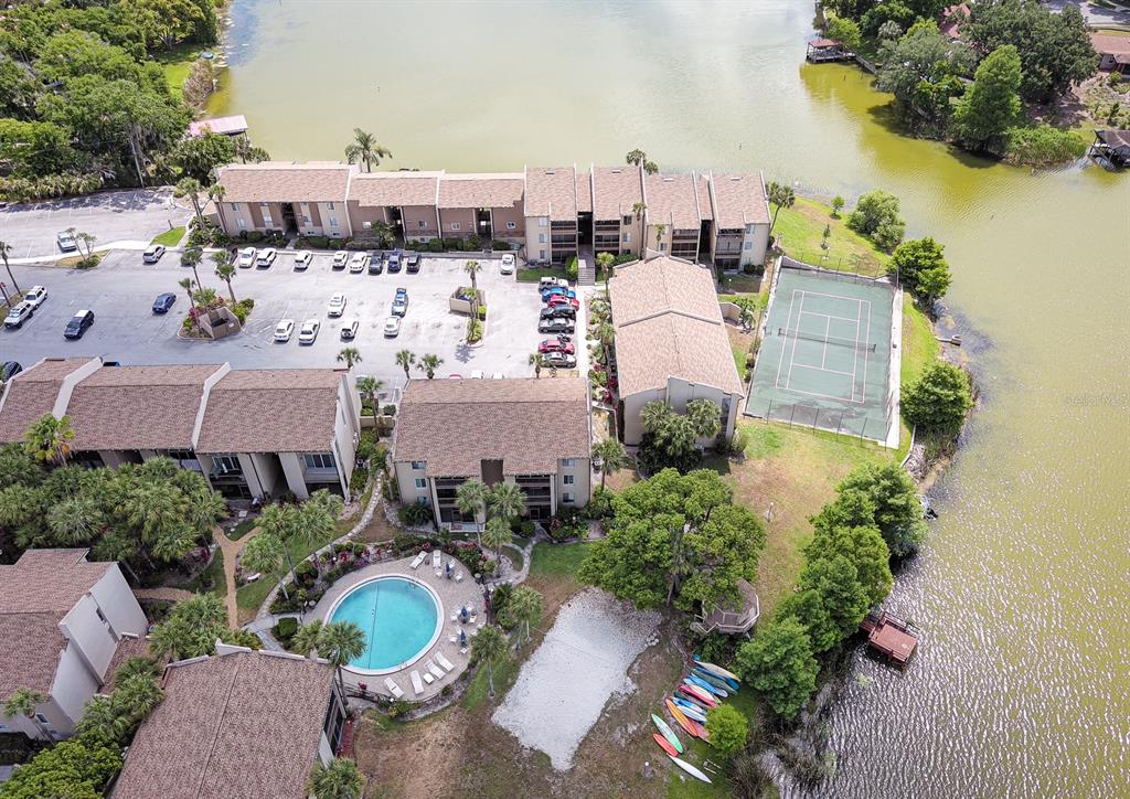 an aerial view of a house with a yard and lake view