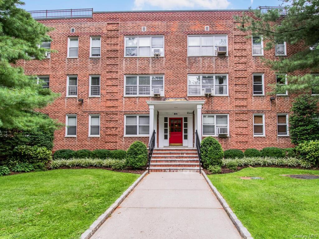 a front view of a building with garden