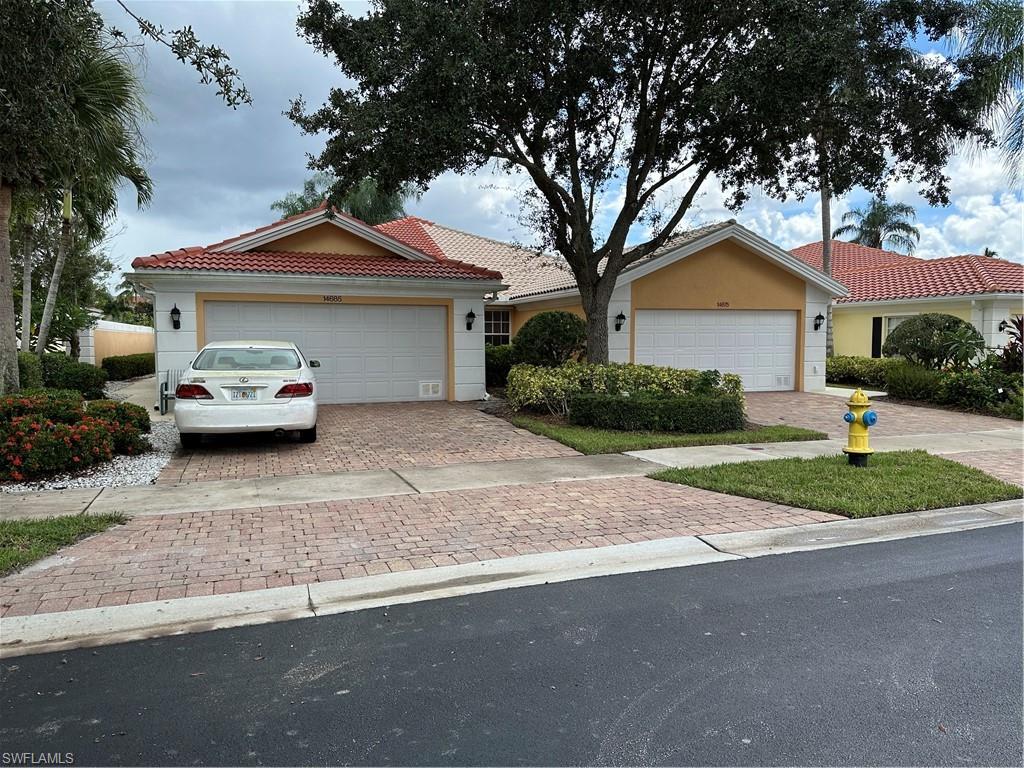 a car parked in front of a house with a yard