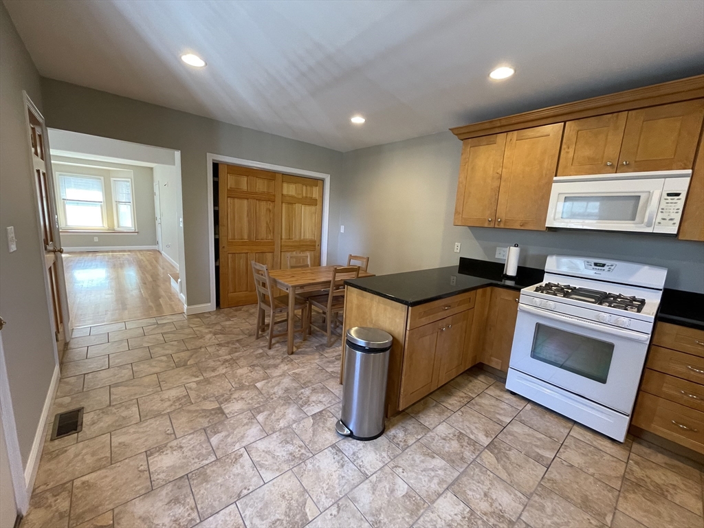 a kitchen with sink cabinets and stove top oven