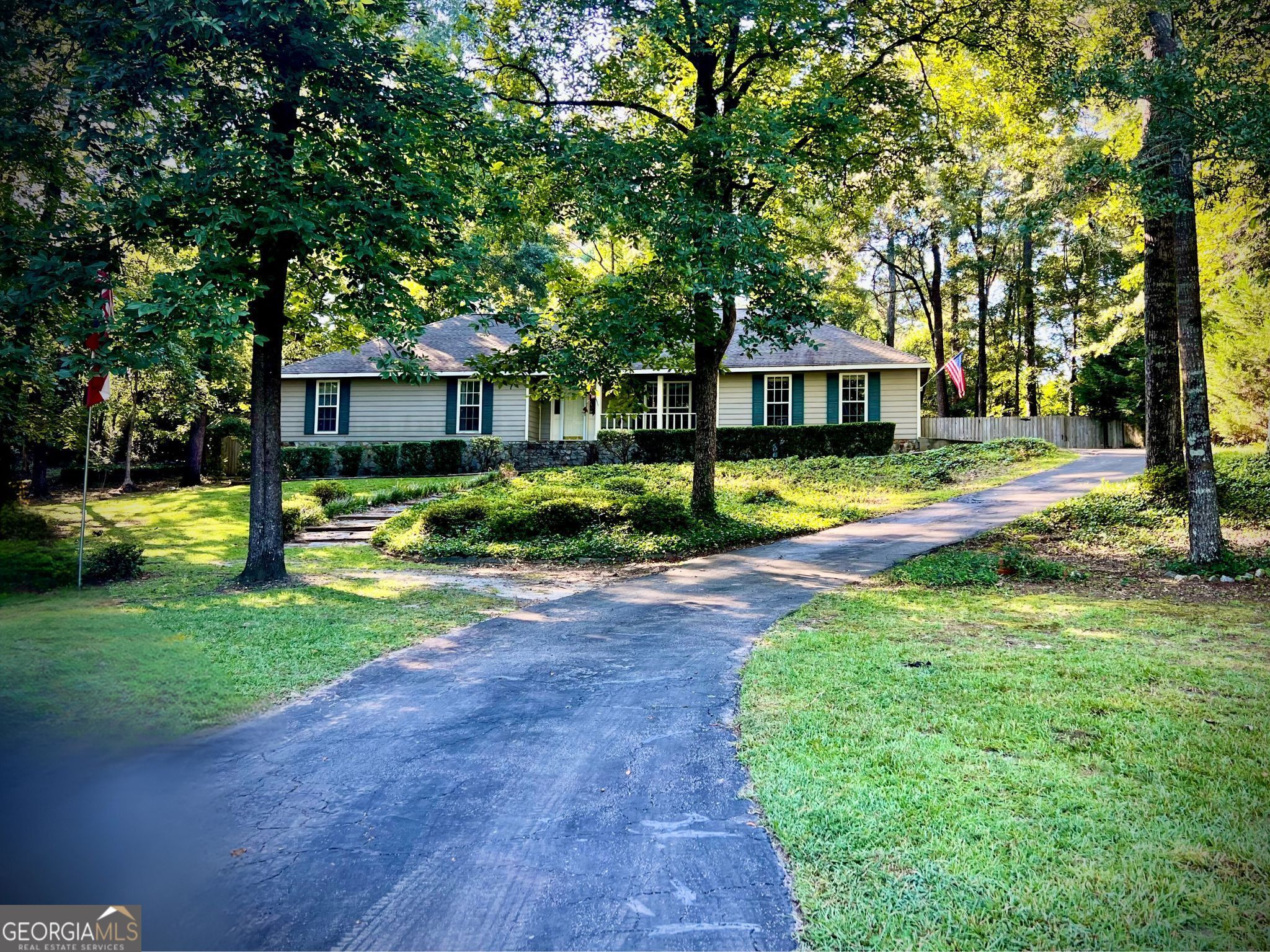 a view of a house with a patio and a yard