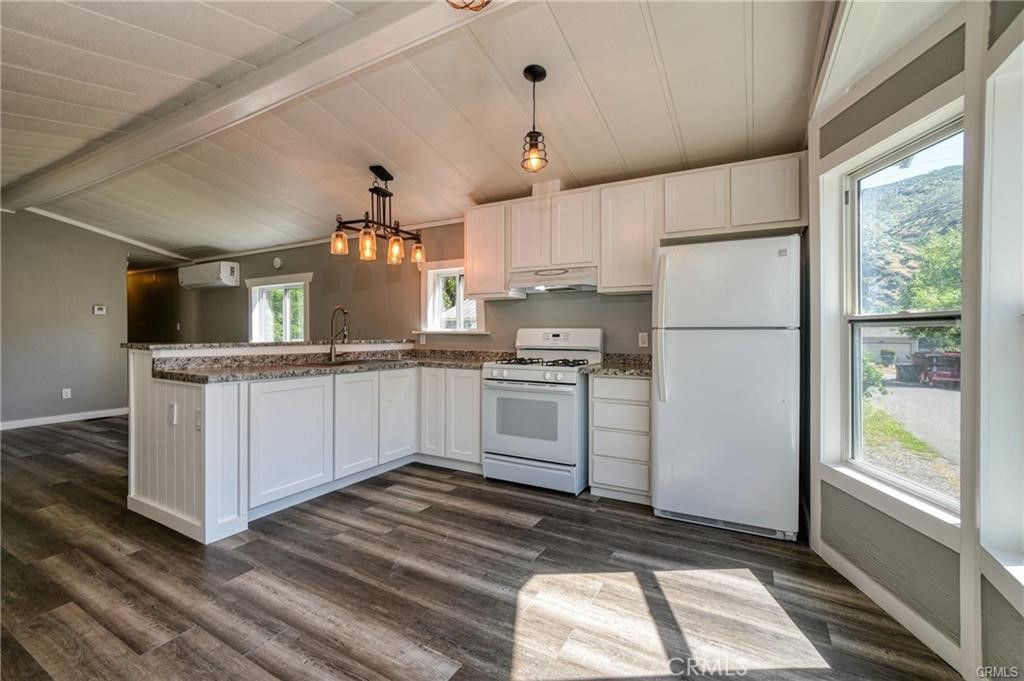 a kitchen with white cabinets and white appliances