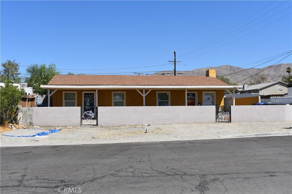 a front view of a house with a road