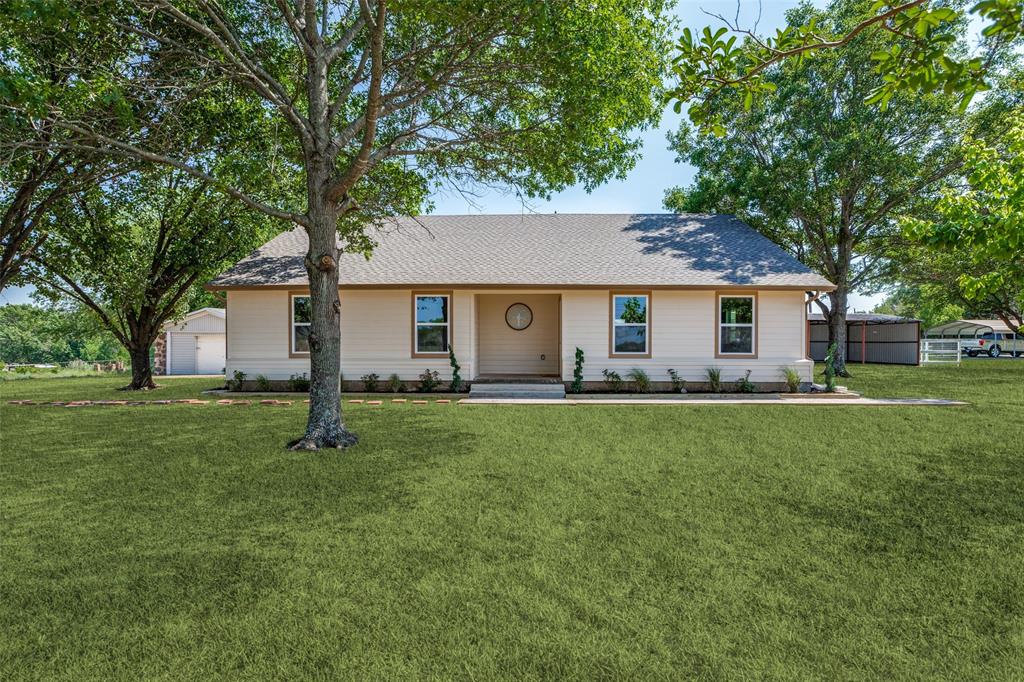 a front view of house with yard and green space