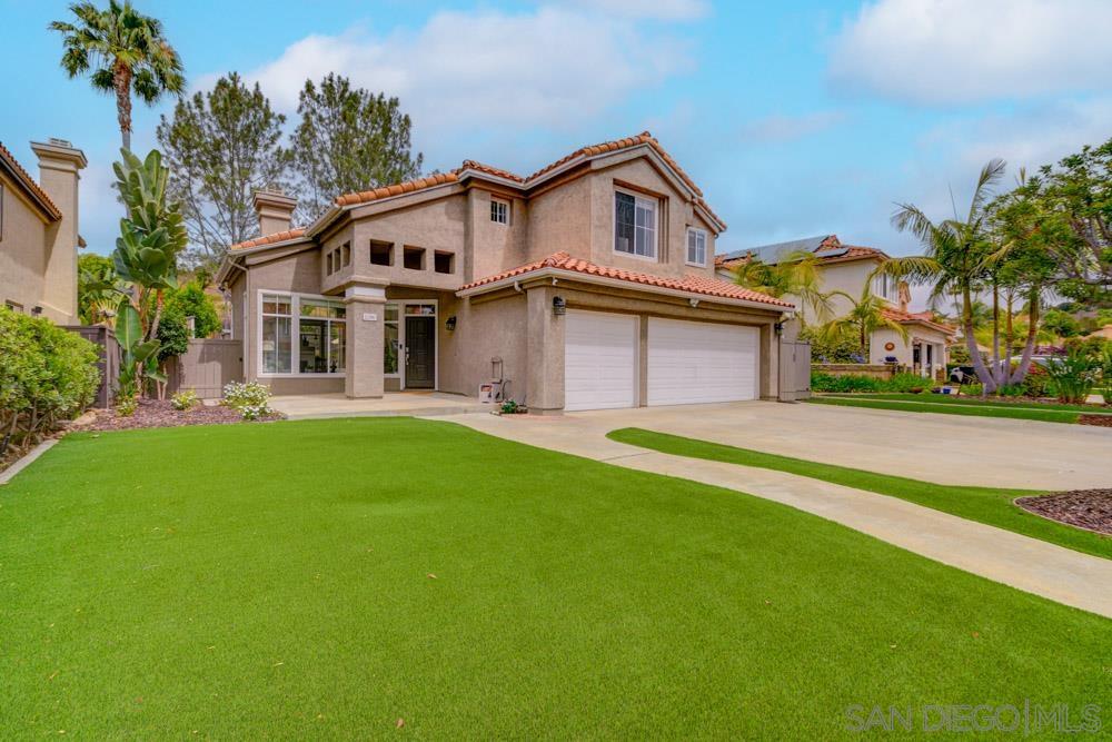 a front view of a house with a garden and yard