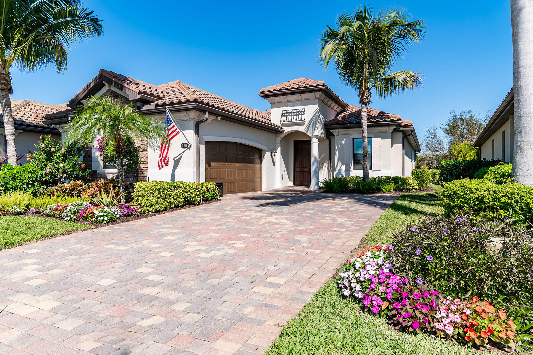 a front view of a house with a garden