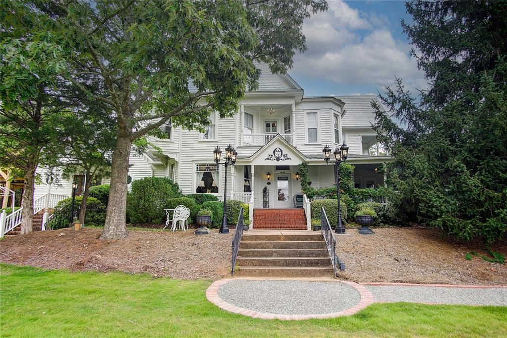 a front view of a house with a yard fire pit and outdoor seating