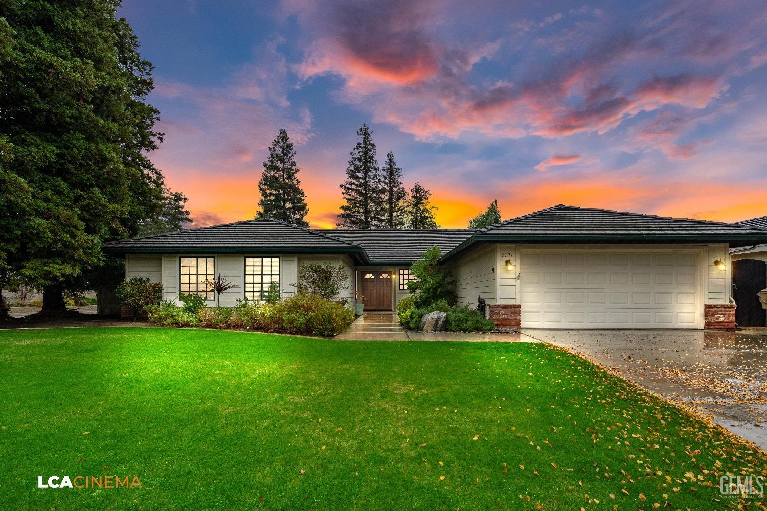 a front view of a house with a garden and yard