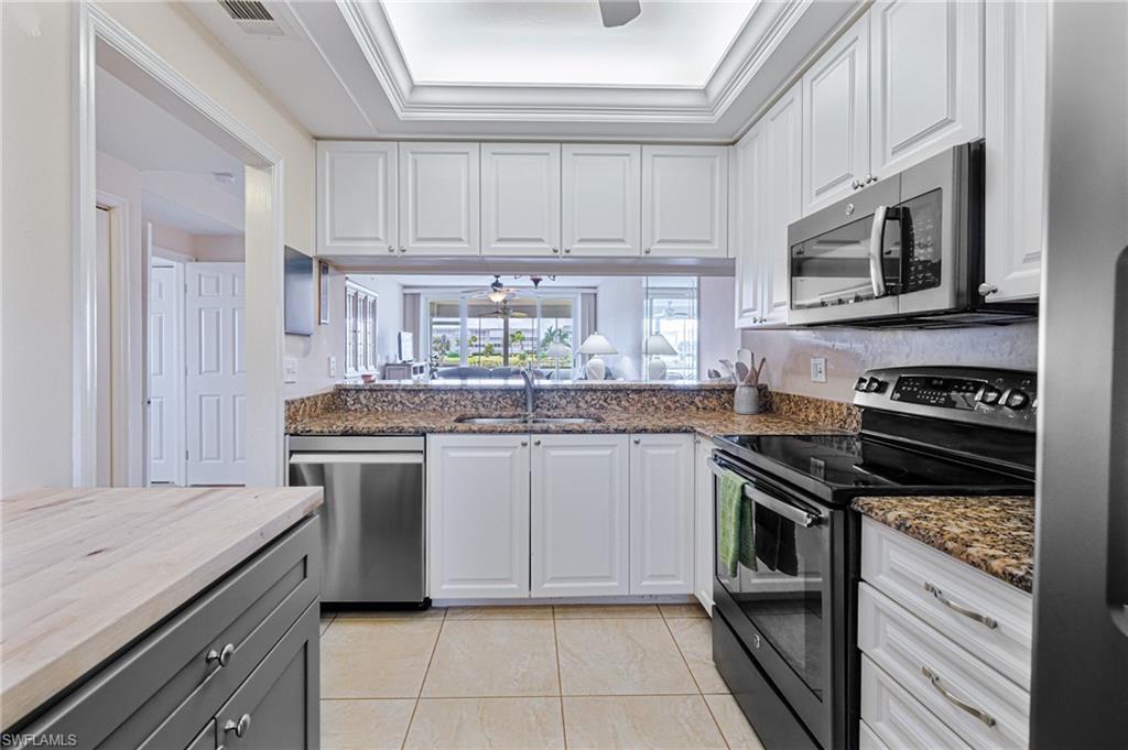 a kitchen with stainless steel appliances granite countertop a stove and a microwave