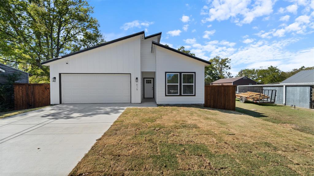 a view of a house with a yard and garage