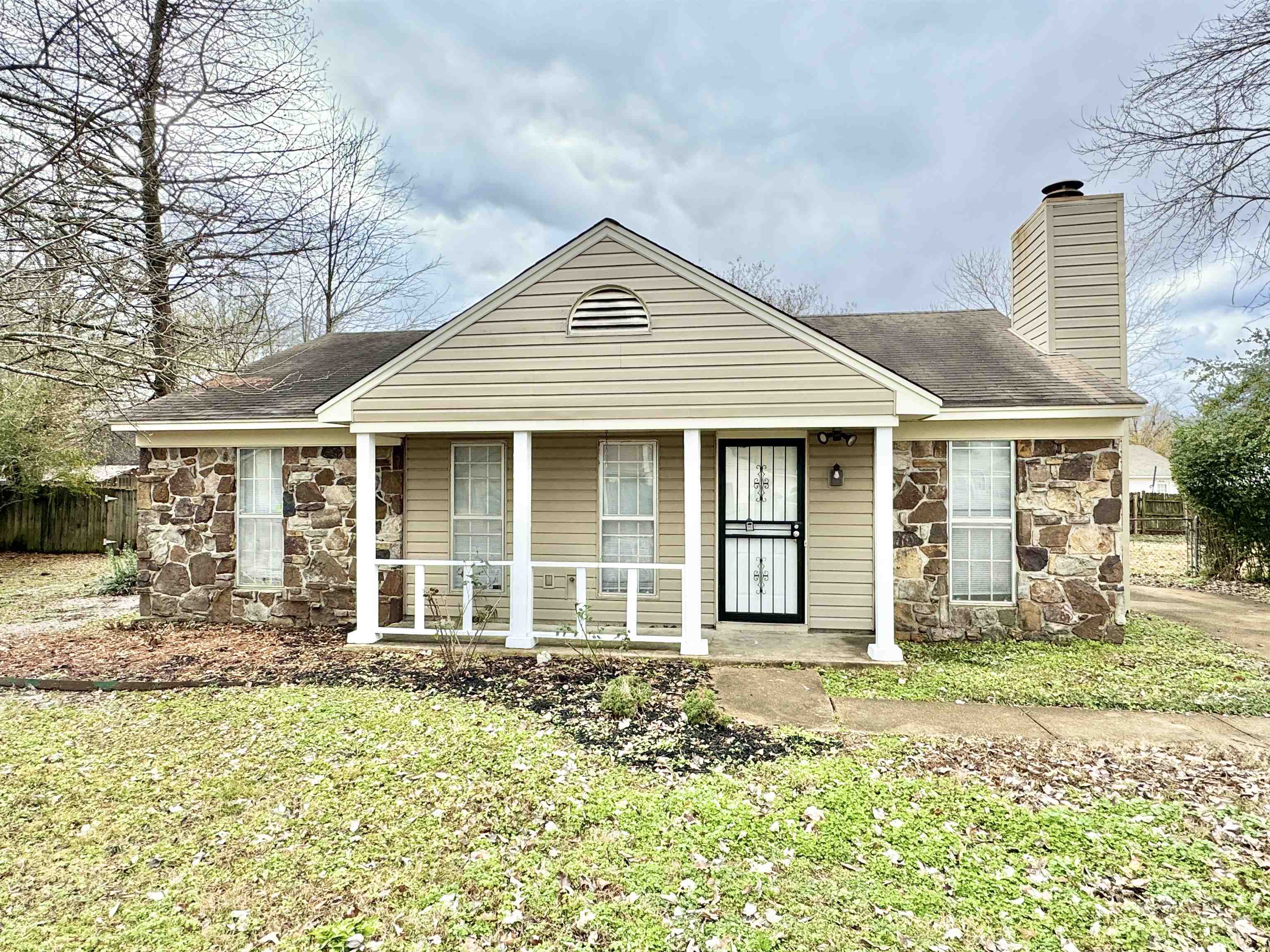 Bungalow-style house with covered porch and a front yard