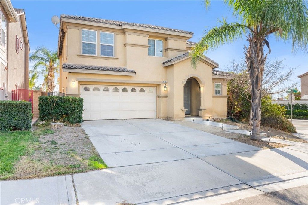 a view of a house with a yard and palm trees