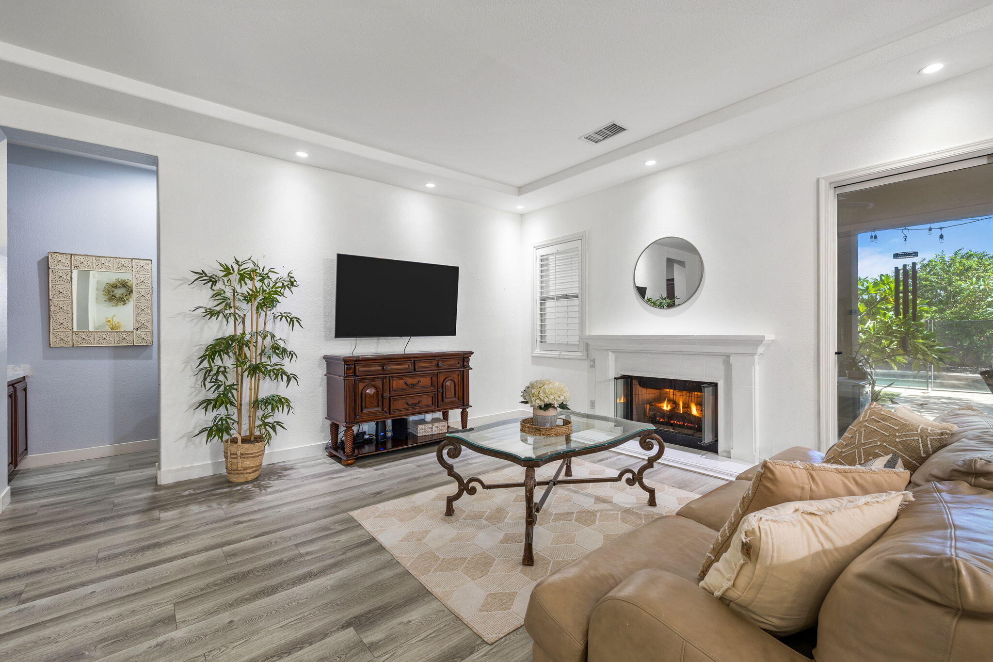 a living room with furniture a fireplace and a flat screen tv