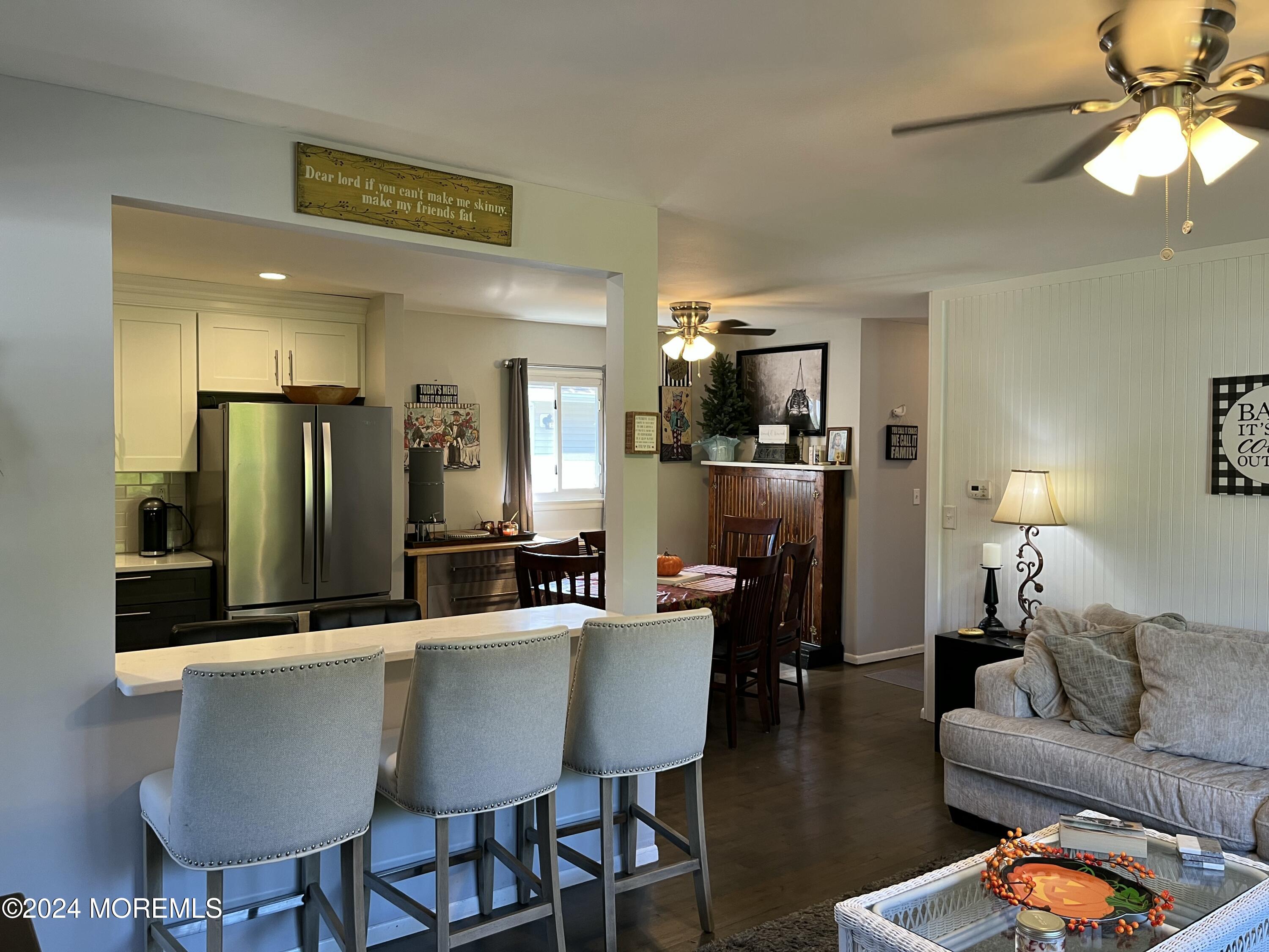 a living room with stainless steel appliances kitchen island granite countertop furniture and a kitchen view