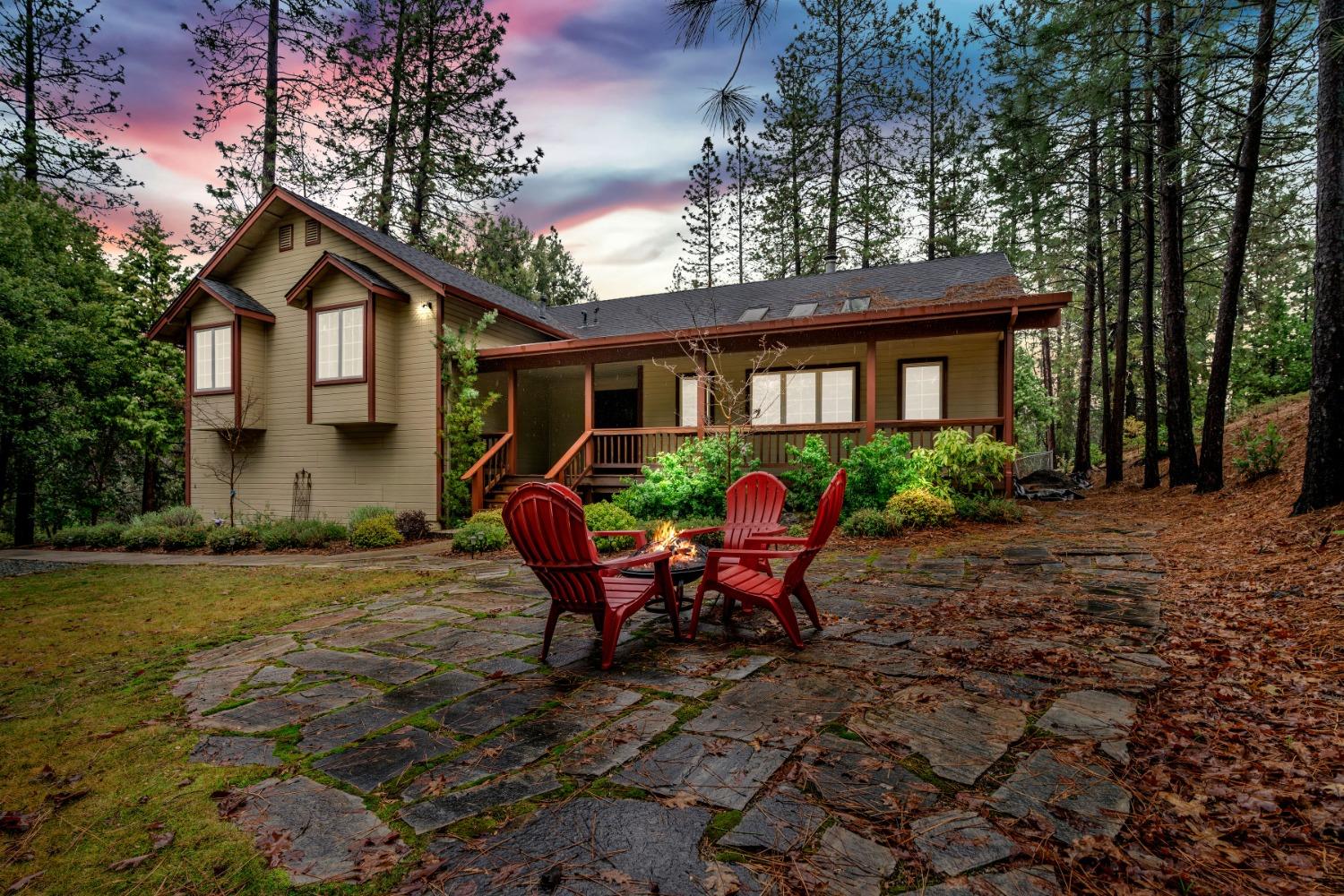 a view of a house with backyard and sitting area