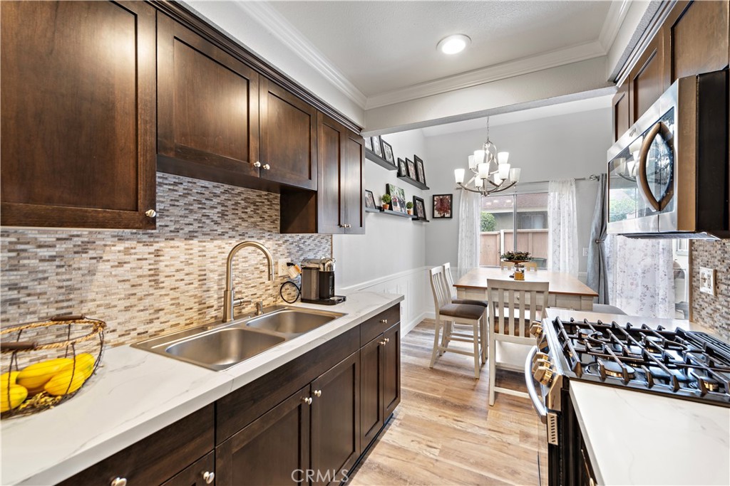 a kitchen with lots of counter top space and stainless steel appliances