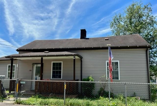 a view of a house with a window and wooden fence