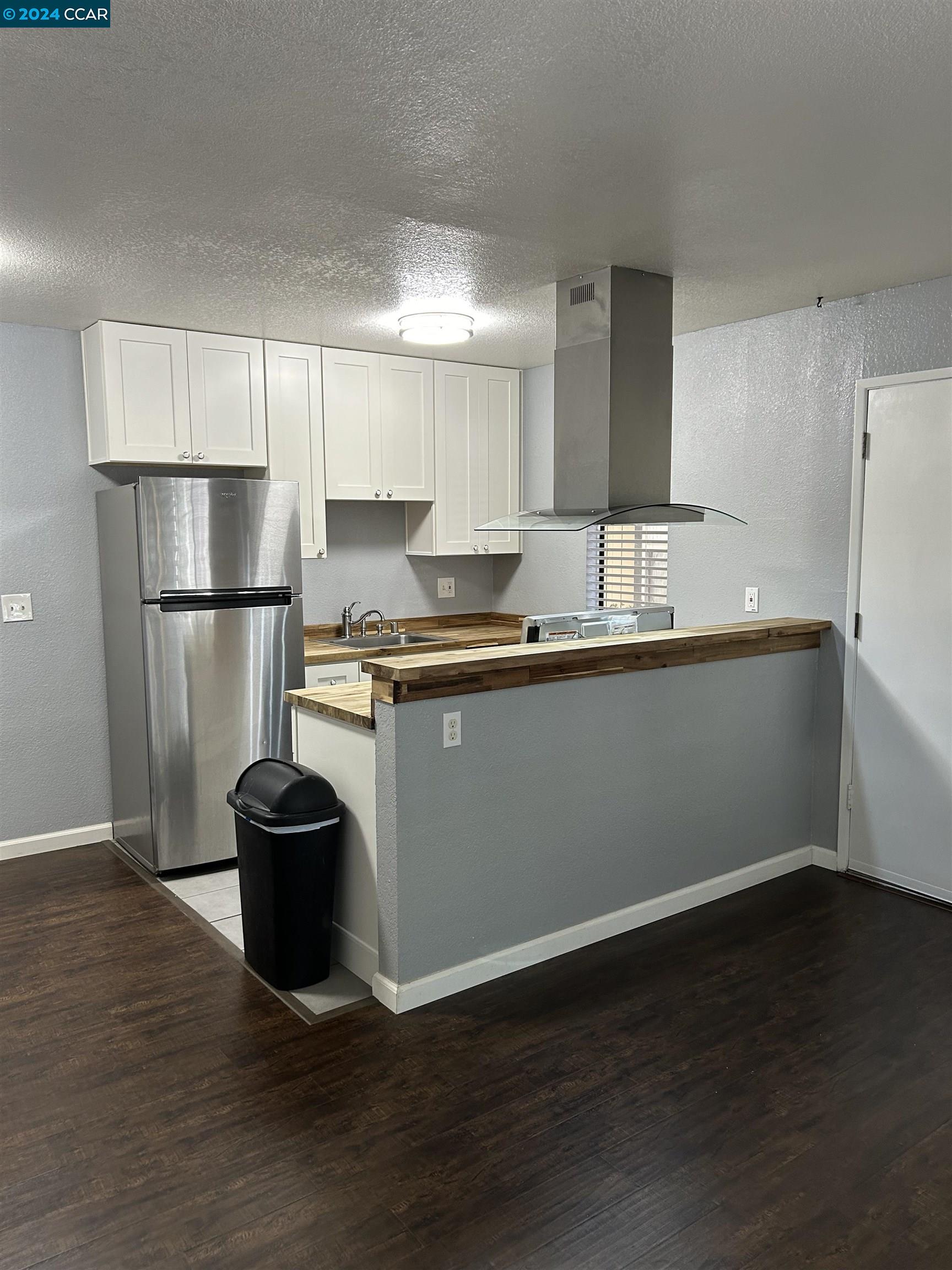 a kitchen with a sink stainless steel appliances and cabinets