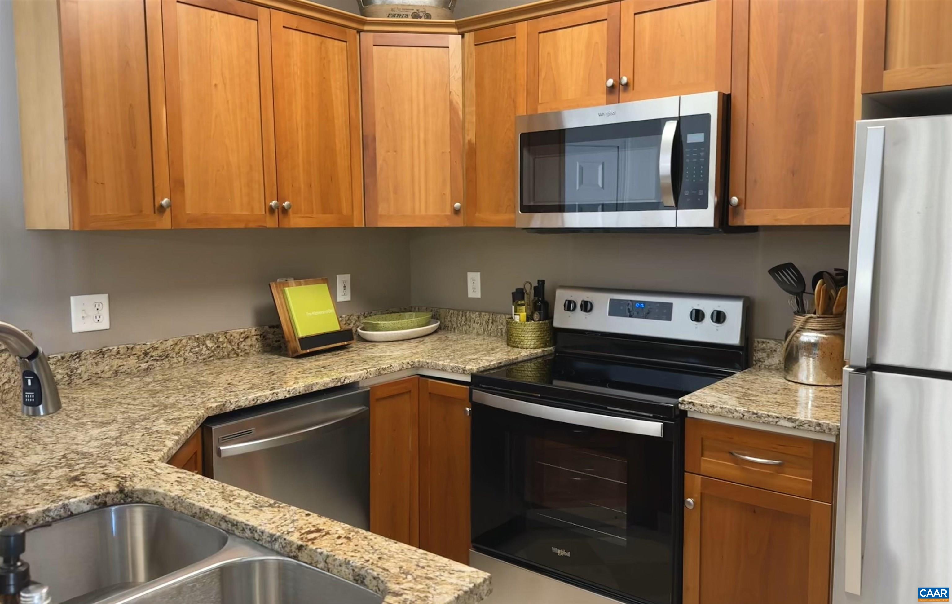 a kitchen with stainless steel appliances granite countertop a sink stove and microwave