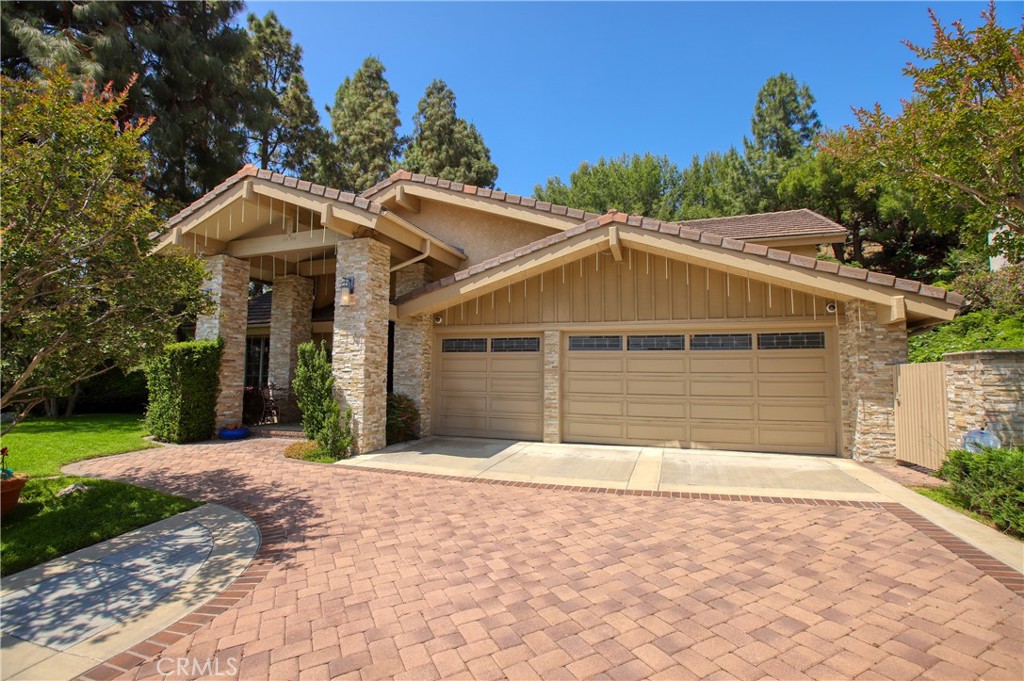 a front view of a house with a yard and trees