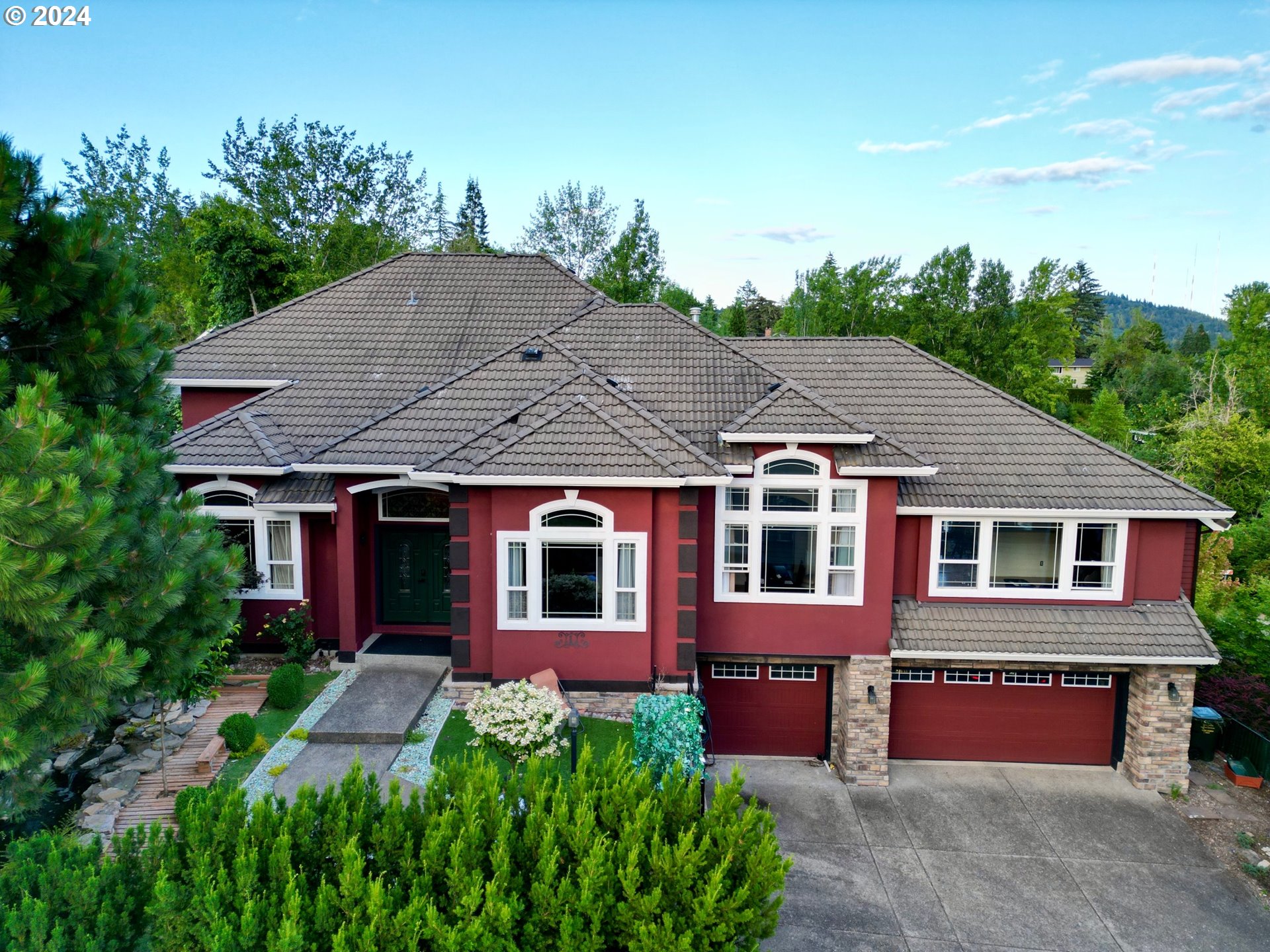 a aerial view of a house with a yard and potted plants