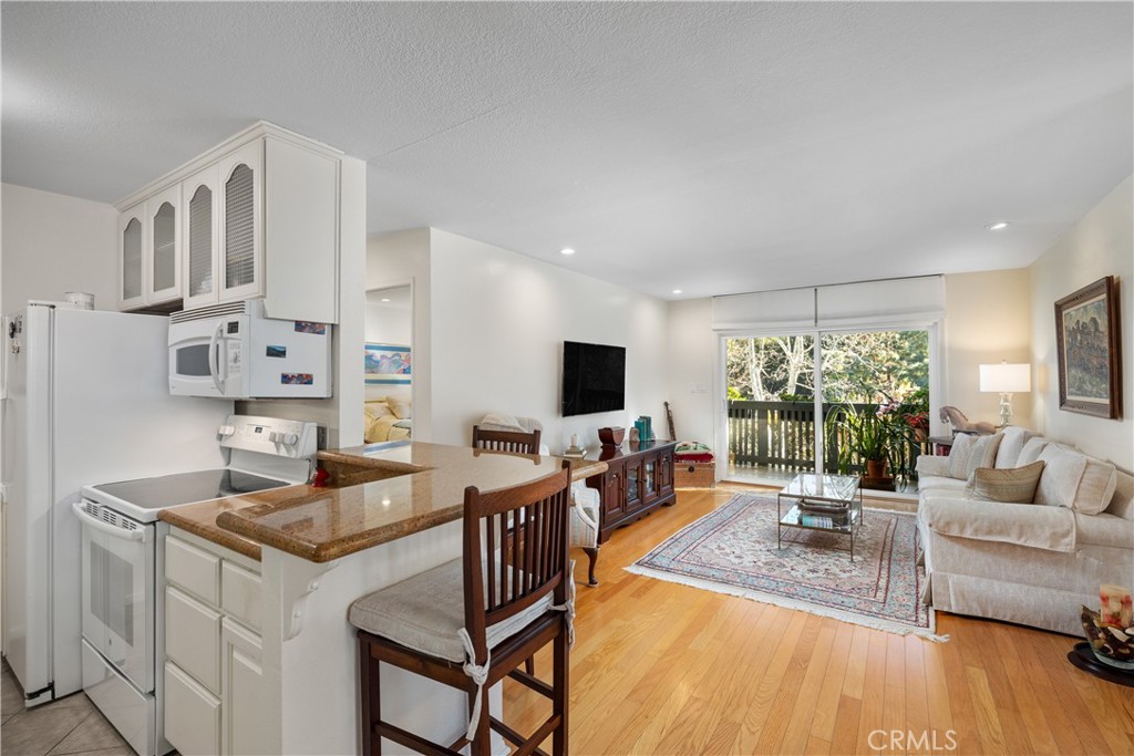 With hardwood floors, beautifully updated kitchen, recessed lighting, and large balcony.