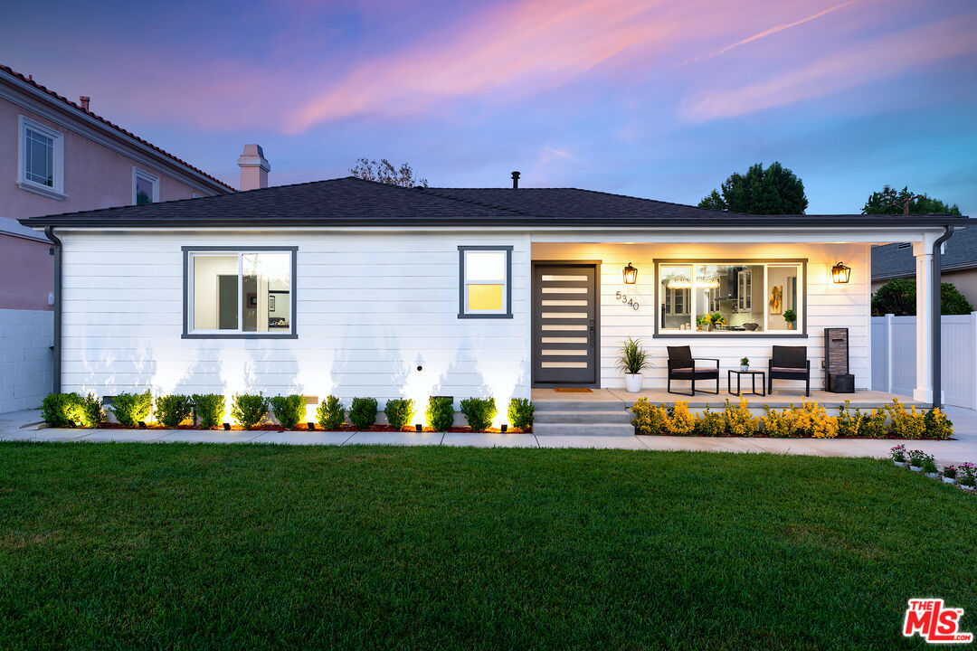 a front view of house with yard and outdoor seating