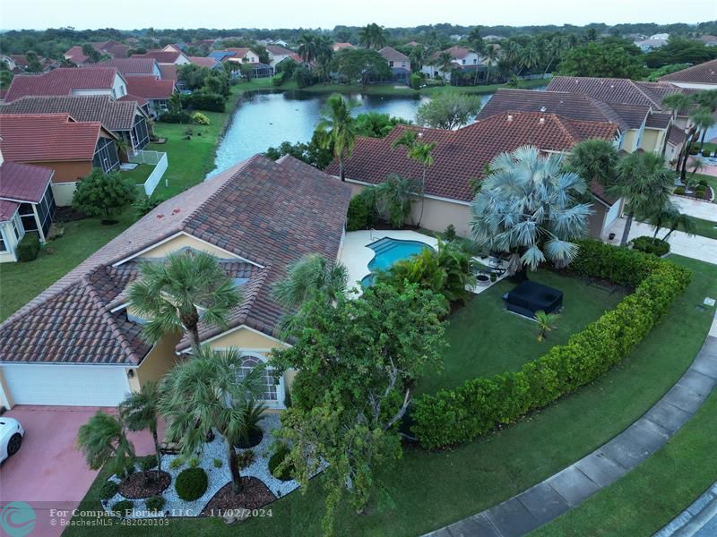 an aerial view of a house with garden space and lake view