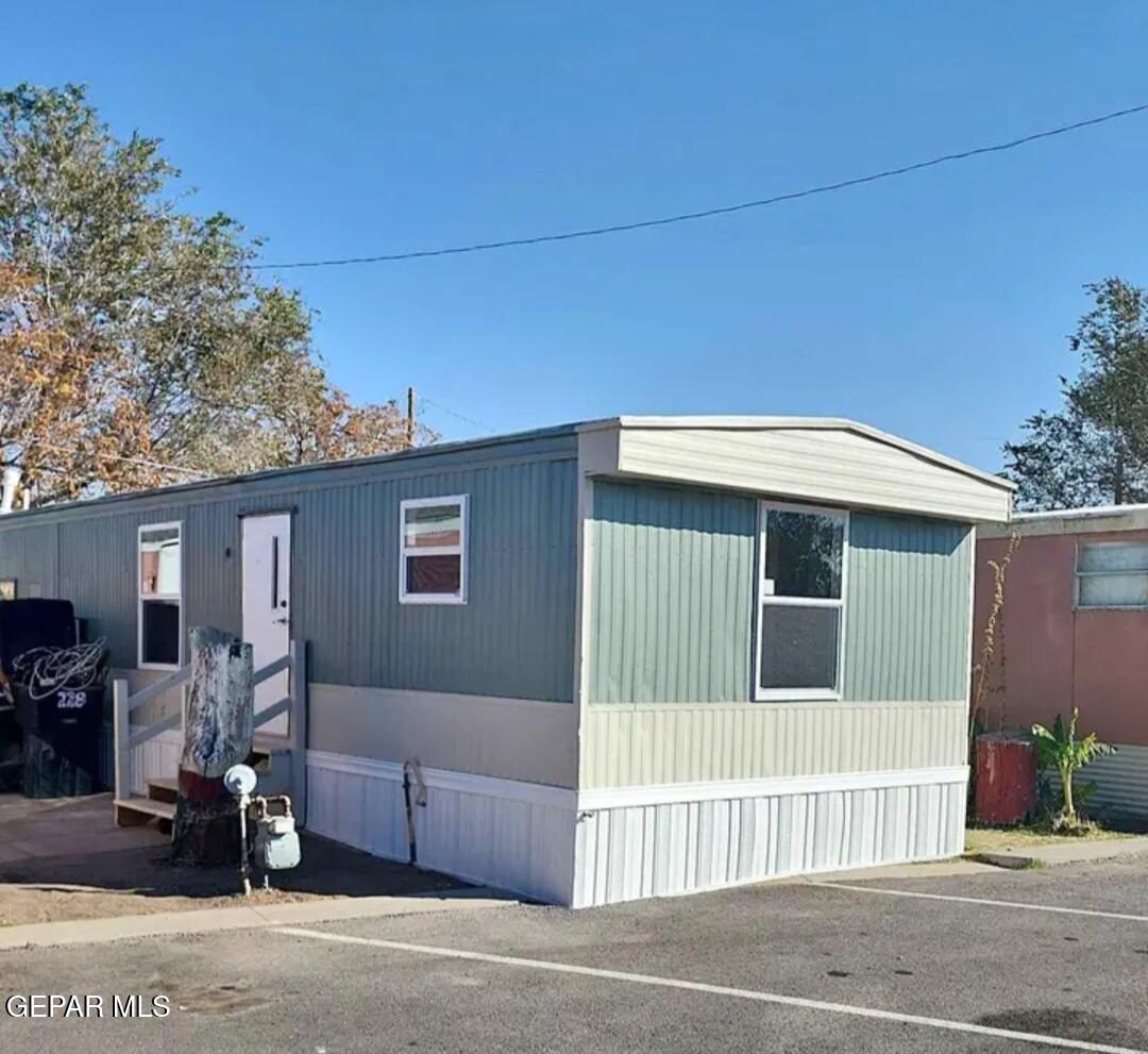 a house that has a tree in front of it