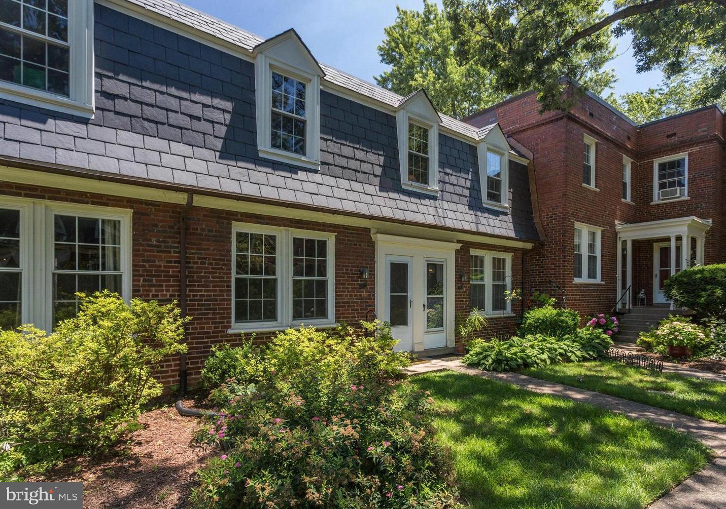 front view of a brick house with a large windows