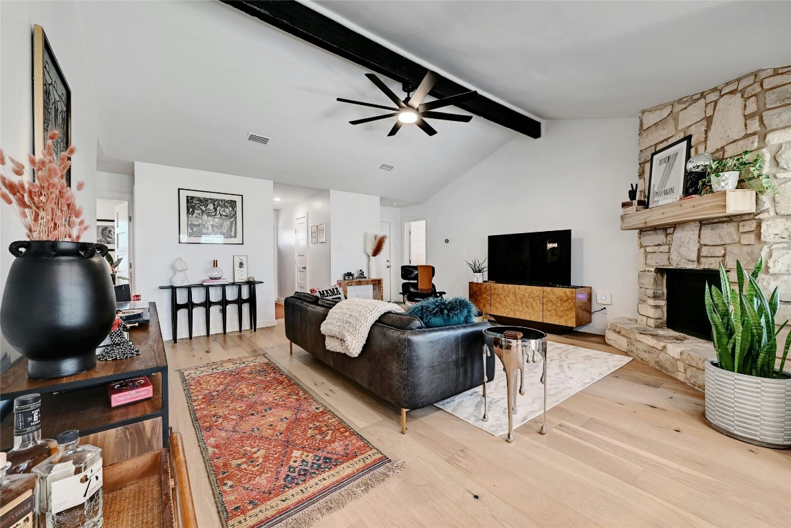 a living room with furniture a fireplace and a flat screen tv