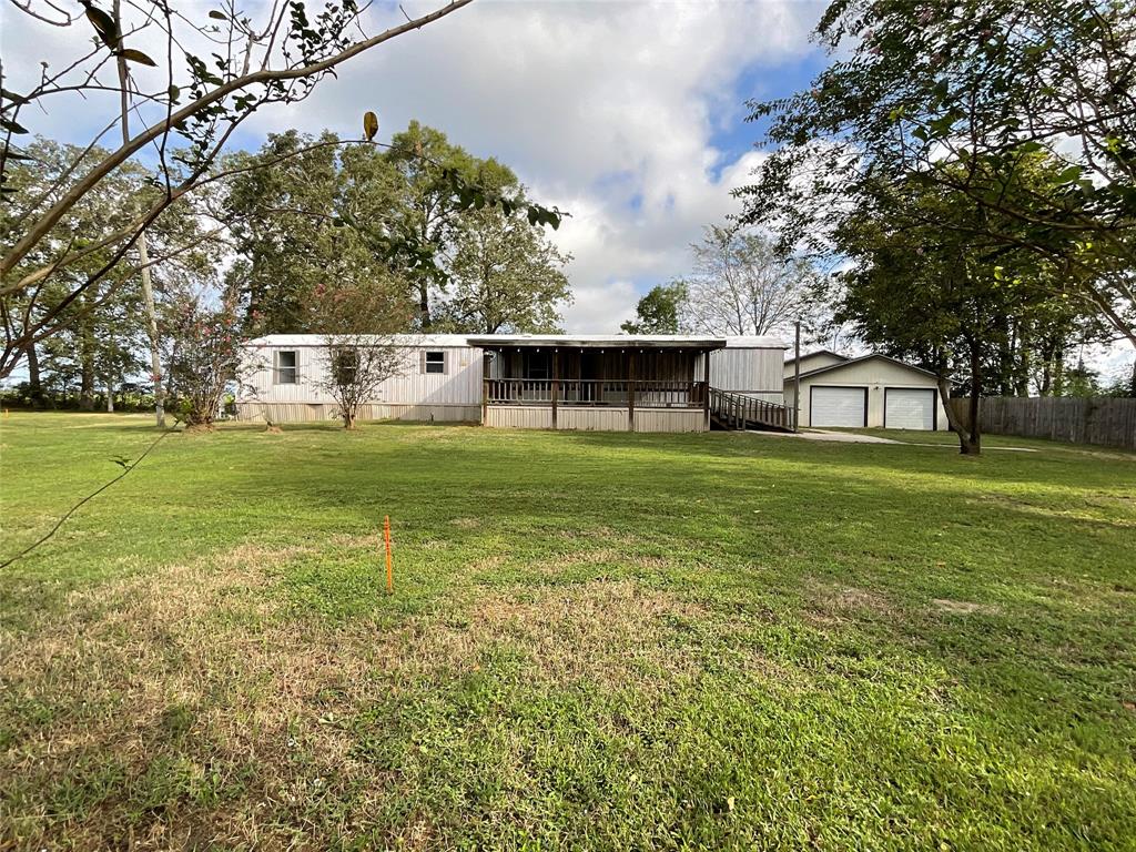 a view of a house with a yard and sitting area