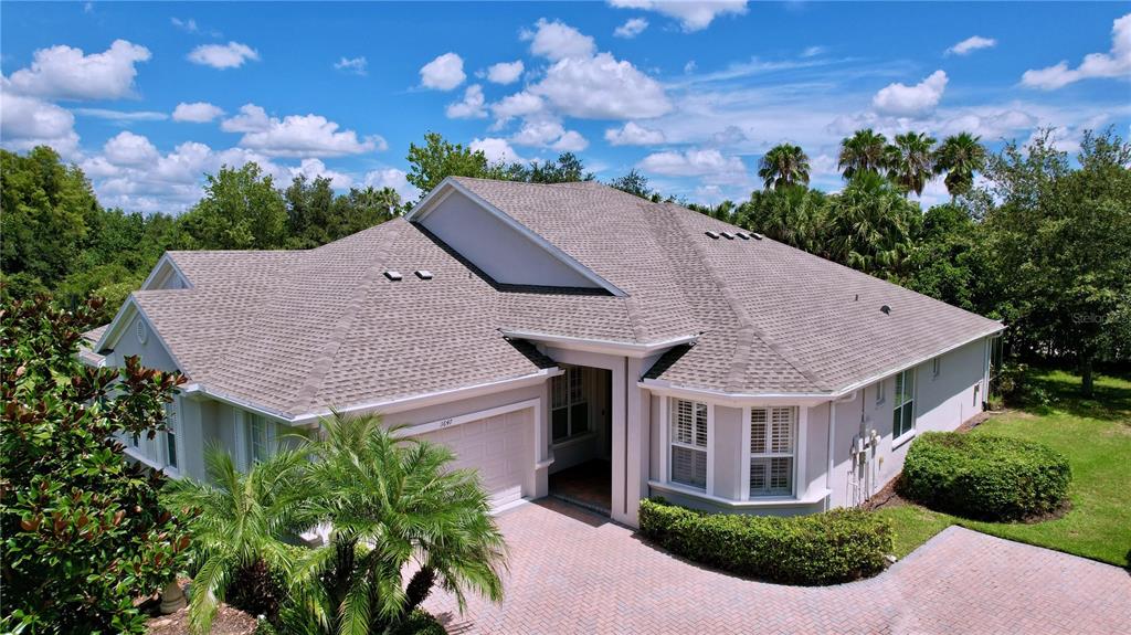 a aerial view of a house with a yard and potted plants